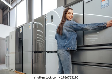 Young Happy Woman Leaning On Her New Refrigerator In A Mall