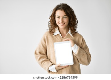 Young happy woman model student holding digital tablet computer showing blank empty mock up screen display advertising software, website or web service standing isolated on white background. - Powered by Shutterstock