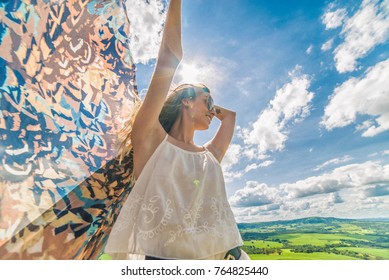 Young happy woman in mountain with fabric. Summer picnic. Happy woman enjoying nature and sunlight.  - Powered by Shutterstock