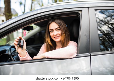 Young happy woman near the car with keys in hand - concept of buying car - Shutterstock ID 647047390