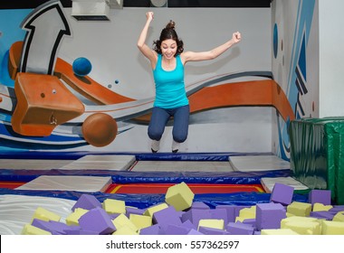 Young Happy Woman Playing In Children Foam Pit Ball