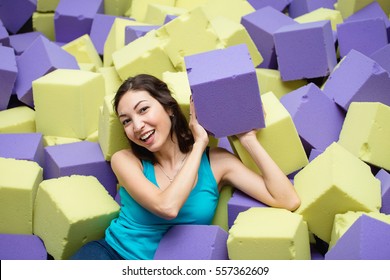 Young Happy Woman Playing In Children Foam Pit Ball