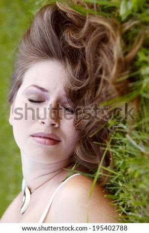 young happy woman relaxing and enjoying life in nature