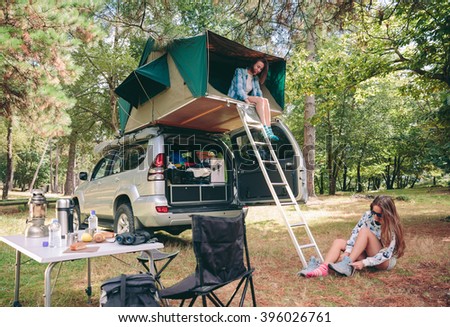 Similar – Women resting and talking lying in tent over car