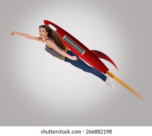 Young Happy Woman Riding Drawing A Cartoon Rocket.