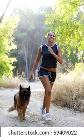 Young Happy Woman Running With Her Dog