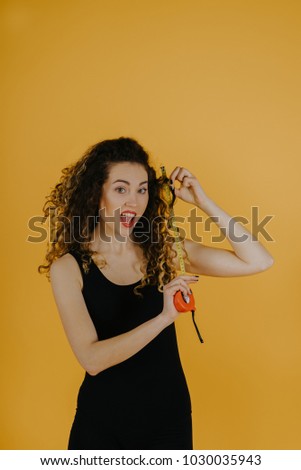 Young happy woman shows the length of her hair