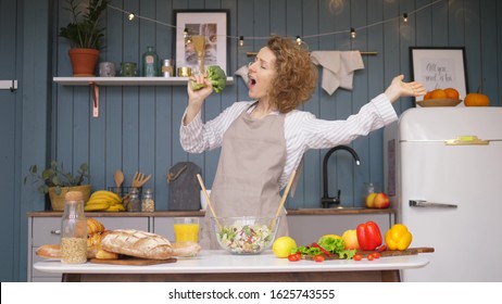 Young Happy Woman Singing And Dancing On Kitchen While Cooking Healthy Food. - Shutterstock ID 1625743555
