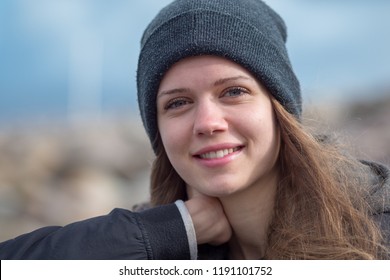Young and happy woman smiles at the camera