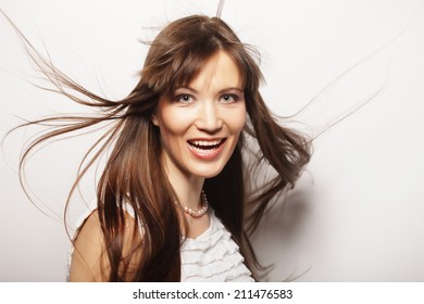 Young happy woman with wind in hair - Shutterstock ID 211476583