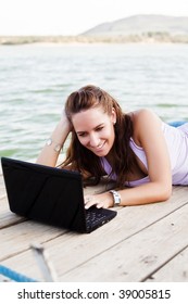 Young happy woman working with her laptop
