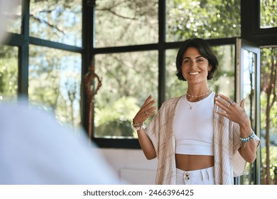 Young happy woman yoga coach training group class yoga meditation session sitting in yoga pose in studio speaking to community teaching people during retreat holistic mind body health therapy. - Powered by Shutterstock