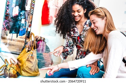 Young happy women watching display at fashion week moda shop - Best female friends sharing free time having fun shopping at city center - Bright vivid filter - Shutterstock ID 2064720911
