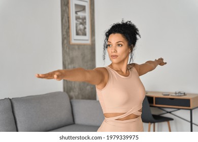 Young Healthy African American Mixed Race Girl Standing At Home Doing Fitness Exercises Meditating Breathing Deeply Feeling Balance, Harmony And No Stress. Mental Health Care Concept.