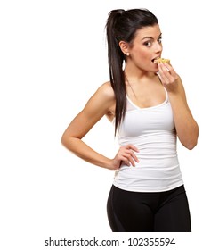 Young Healthy Girl Eating A Cereal Bar Over A White Background