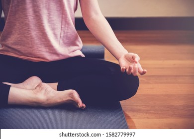 young healthy woman practicing yoga lesson, lotus pose with instructor in home studio, wellness, fitness lifestyle concept, new year 2024 healthy resolution, exercise workout at home, social distance - Powered by Shutterstock