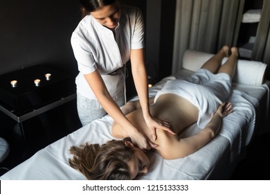 Young And Healthy Woman In Spa Salon. Traditional Swedish Massage Therapy