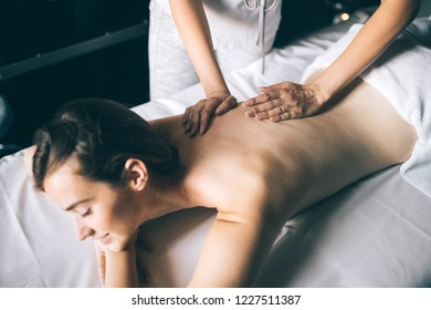 Young And Healthy Woman In Spa Salon. Traditional Swedish Massage Therapy