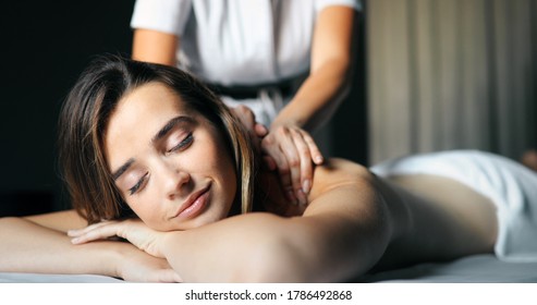 Young And Healthy Woman In Spa Salon. Traditional Swedish Massage Therapy