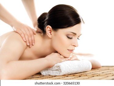 Young And Healthy Woman In Spa Salon. Traditional Swedish Massage Therapy And Beauty Treatments. 