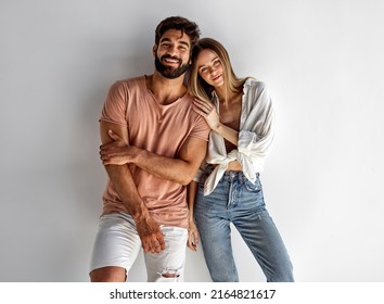 Young Heterosexual Couple Looking At Camera And Smiling 