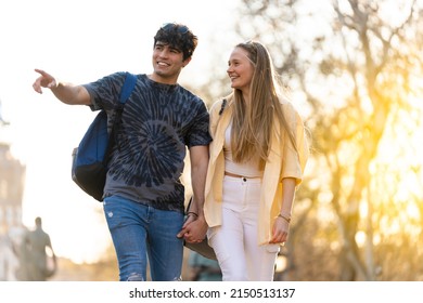 Young Heterosexual Couple Walking In A Park And Talking