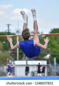 Young High School Boy Competing In The High Jump At A Track Meet