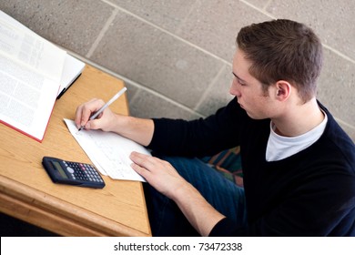 A Young High School Or College Student Working On His Math Homework.