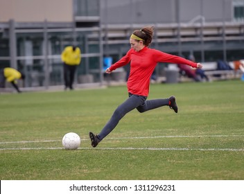 Young High School Girl Competing In A Soccer Game