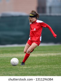 Young High School Girl Competing In A Soccer Game