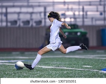 Young high school girl playing in a soccer match - Powered by Shutterstock