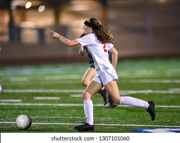 Young High School Girl Playing In A Soccer Match