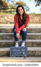 Young High School Senior Posing For Graduation Pictures