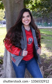 Young High School Senior Posing For Graduation Pictures