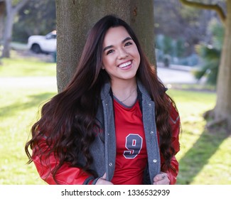 Young High School Senior Posing For Graduation Pictures