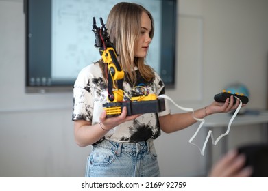 Young High school student girl is presenting her robotic project in classroom - Powered by Shutterstock