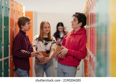 Young high school students meeting and greeting near locker in campus hallway, back to school concept. - Shutterstock ID 2190204285