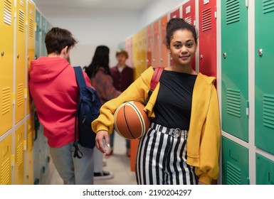 Young high school students meeting and greeting near locker in campus hallway, back to school concept. - Shutterstock ID 2190204297