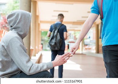 Young highschool student buying drugs in front of minors on school grounds and in school.