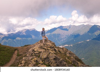Young hiker stand in beautiful mountains on hiking trip. Active person resting outdoors in  nature. Backpacker camping outside recreation active - Shutterstock ID 1808934160