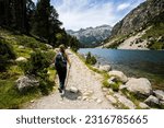 Young hiker woman in Vall de Boi in Aiguestortes and Sant Maurici National Park, Pyrenees, Spain