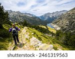 Young hiker woman in Vall de Boi in Aiguestortes and Sant Maurici National Park, Pyrenees, Spain