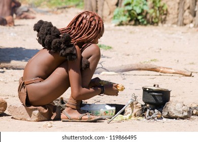 Young Himba Woman Cooks For Lunch.