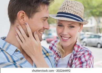 Young Hip Couple Smiling With Woman Smiling At Camera On A Sunny Day In The City