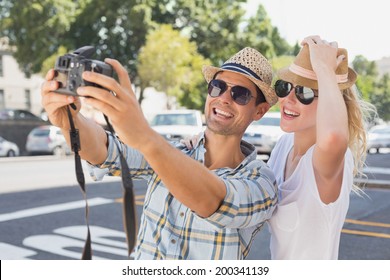 Young Hip Couple Taking A Selfie On A Sunny Day In The City