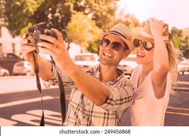 Young Hip Couple Taking A Selfie On A Sunny Day In The City