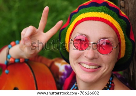 Young hippie woman making peace sign
