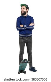 Young Hipster In Blue Tracksuit Jacket And Baseball Cap On Skateboard Looking Away Smiling. Full Body Length Portrait Isolated Over White Studio Background. 