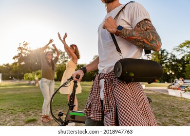 young hipster company of friends having fun together in park smiling listening to music on wireless speaker, dancing party,summer style season