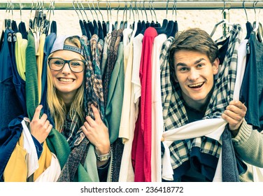 Young hipster couple in love at the weekly flea market - Best friends sharing free time having fun and shopping in the old town - Lovers enjoying everyday life moments on a vintage filtered look - Powered by Shutterstock